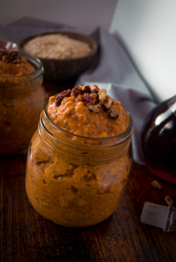 Close up Mason jar pumpkin pie overnight oats walnuts maple syrup 