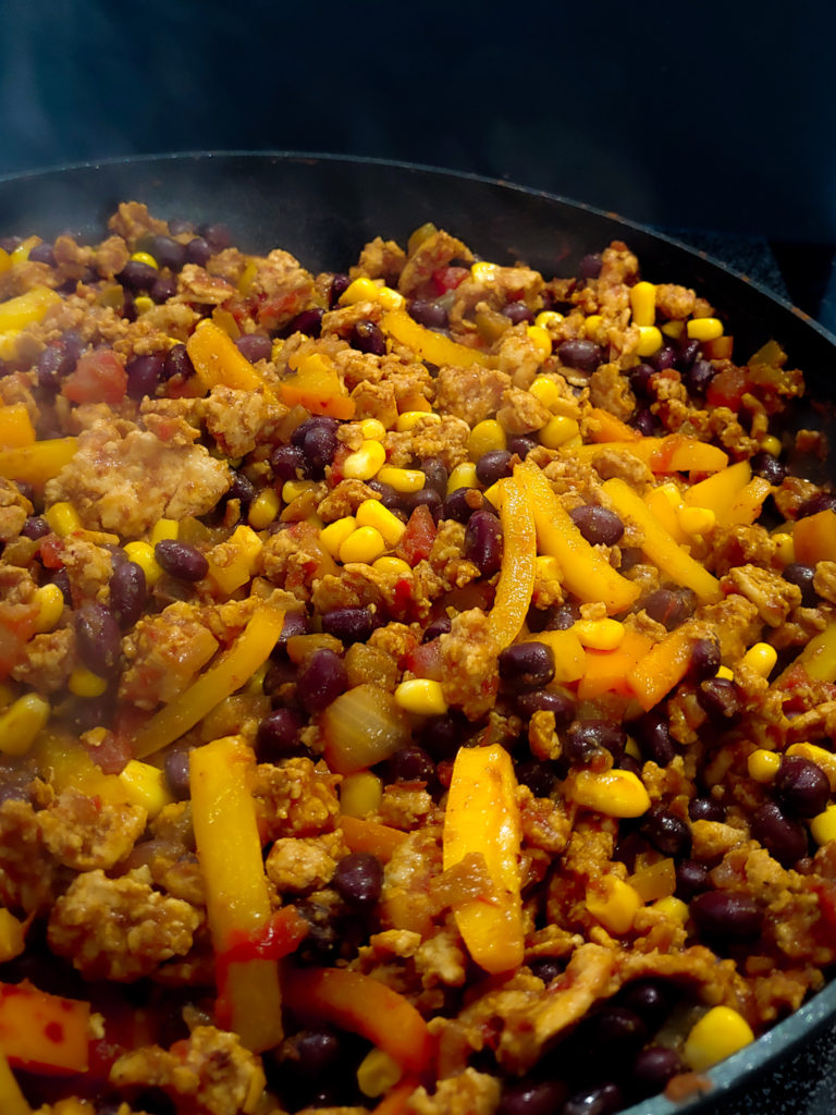 turkey taco bowl mixture in a hot pan pepper black bean corn salsa